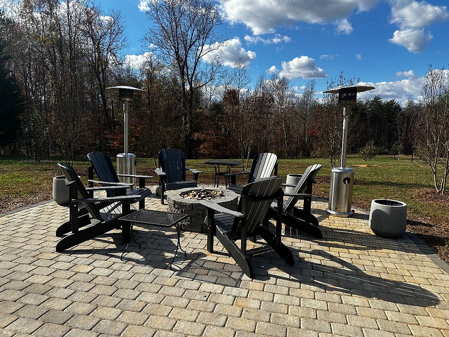Fire pit with Adirondack chairs.