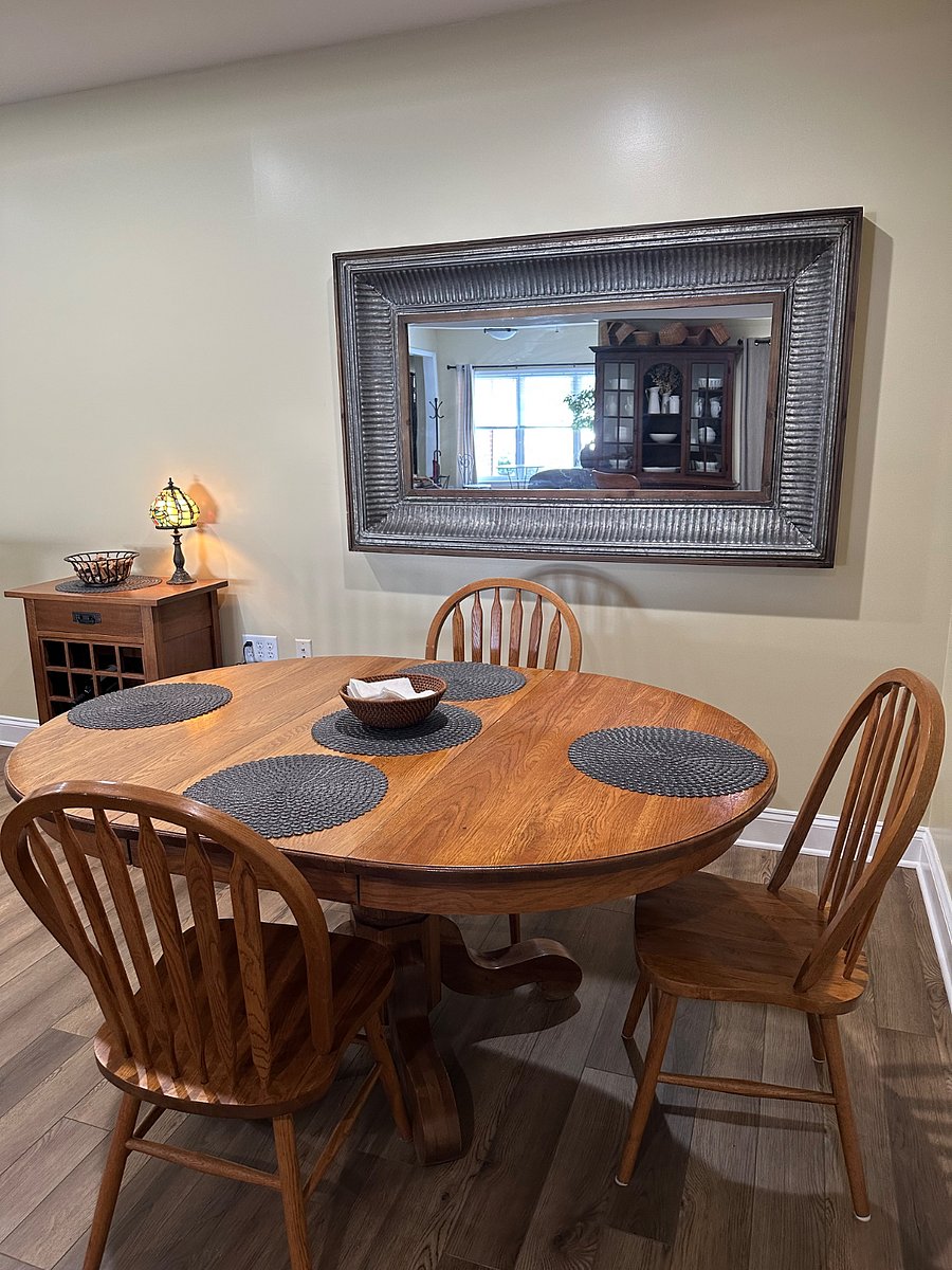 Oak dining table, large vintage mirror, and wine cabinet.