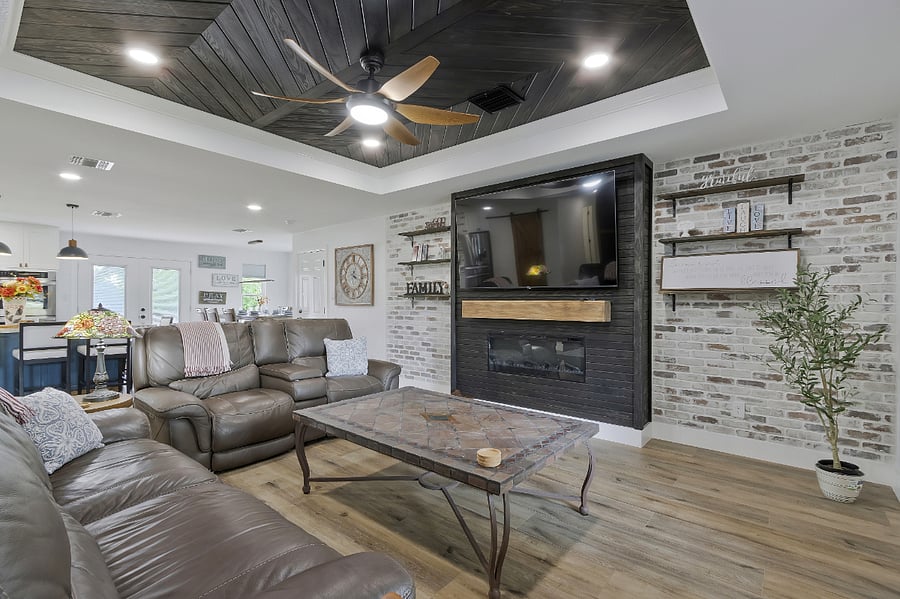 Large Family room open to dining, kitchen, and bar area, with electric fireplace.