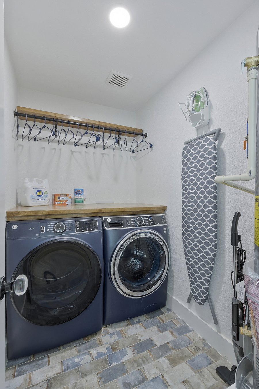 Large capacity washer and dryer with ironing board, iron and ,folding table top