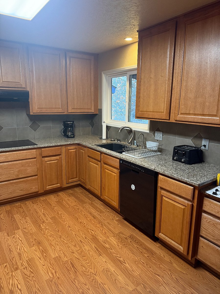 Large kitchen with dishwasher, stovetop, oven, microwave and full size refrigerator.