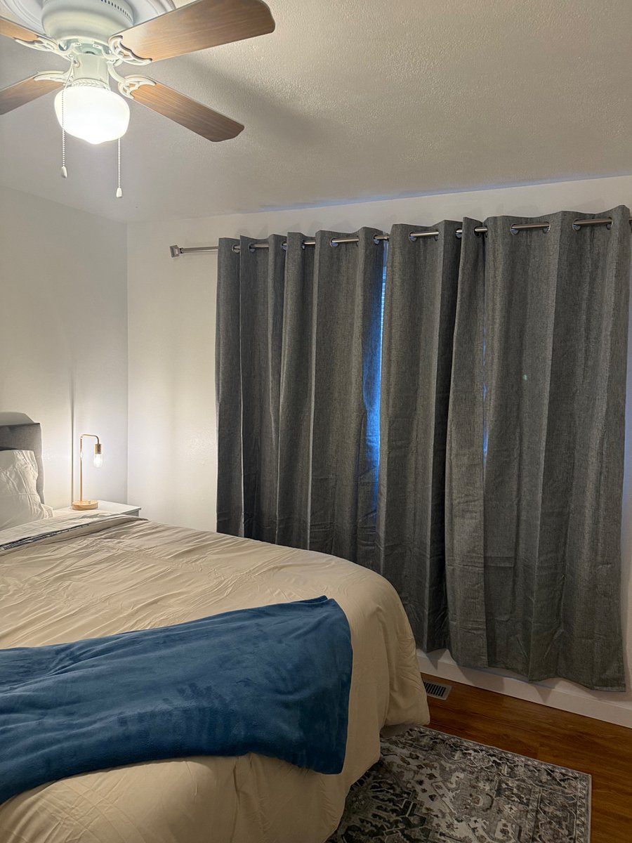 1st bedroom with black out curtains and smart tv