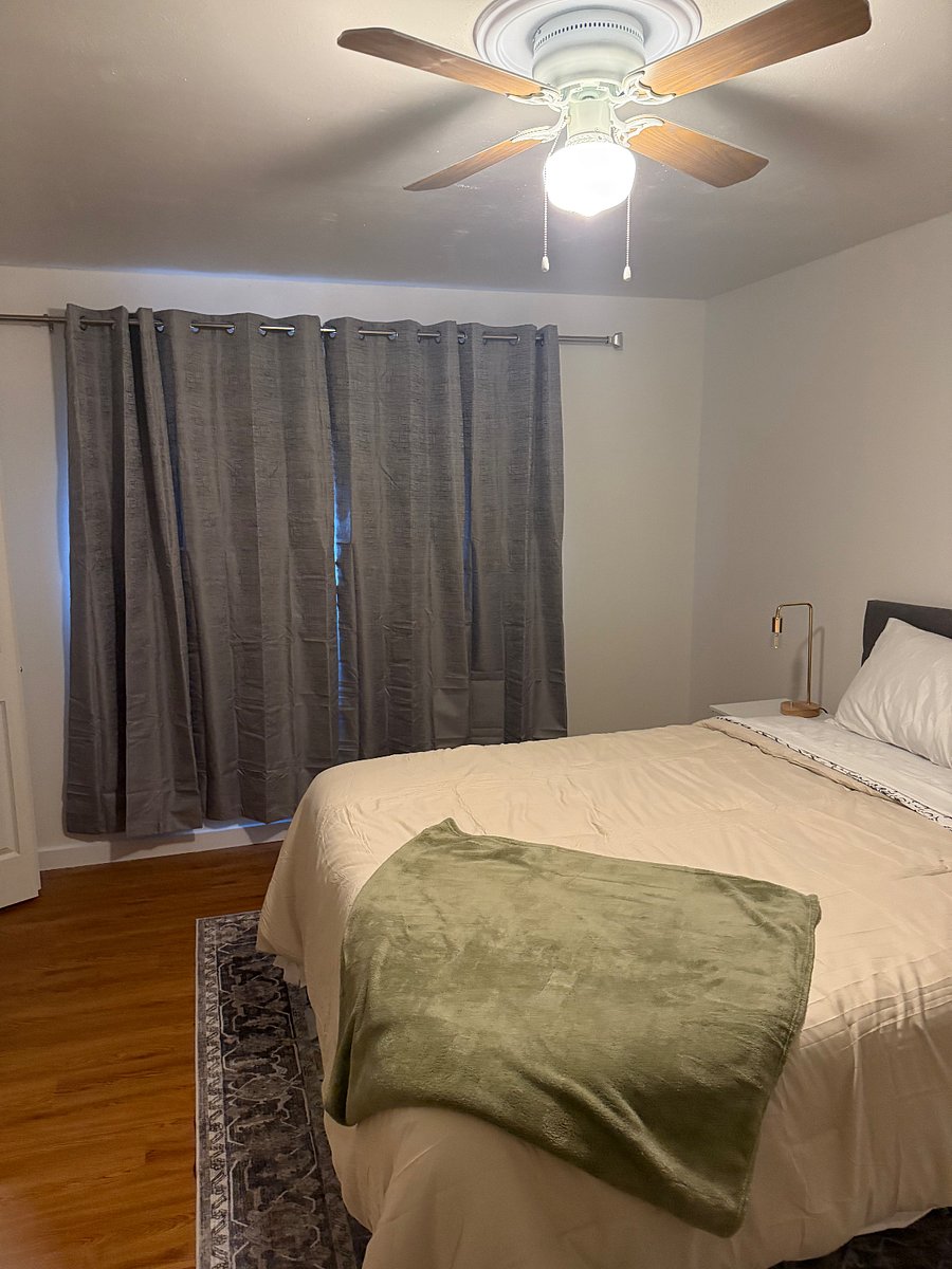 2nd bedroom with blackout curtains and smart tv
