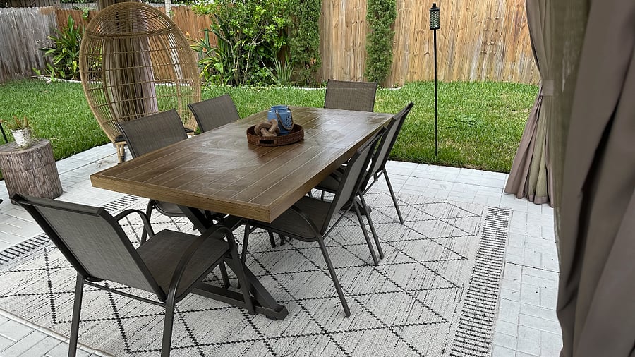 Outdoor seating under gazebo with mosquito netting, fully covered.
