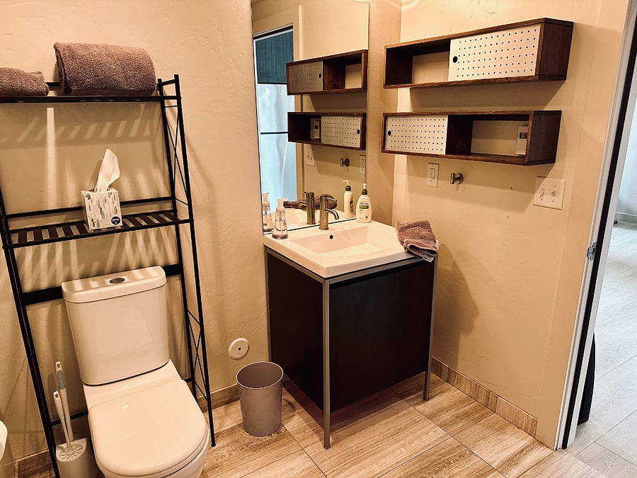 Clean, modern bathroom with walk-in shower and fresh towels provided