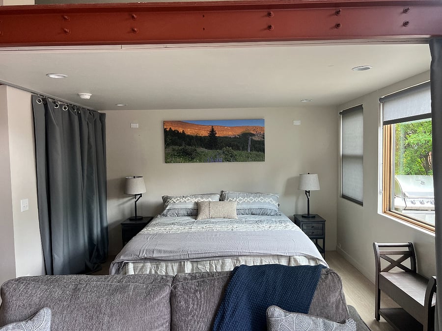 King-size bed with soft linens and plenty of natural lightperfect for restful stays
