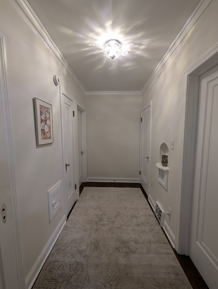 Common hallway in between bedrooms, bathroom, kitchen and dining room.