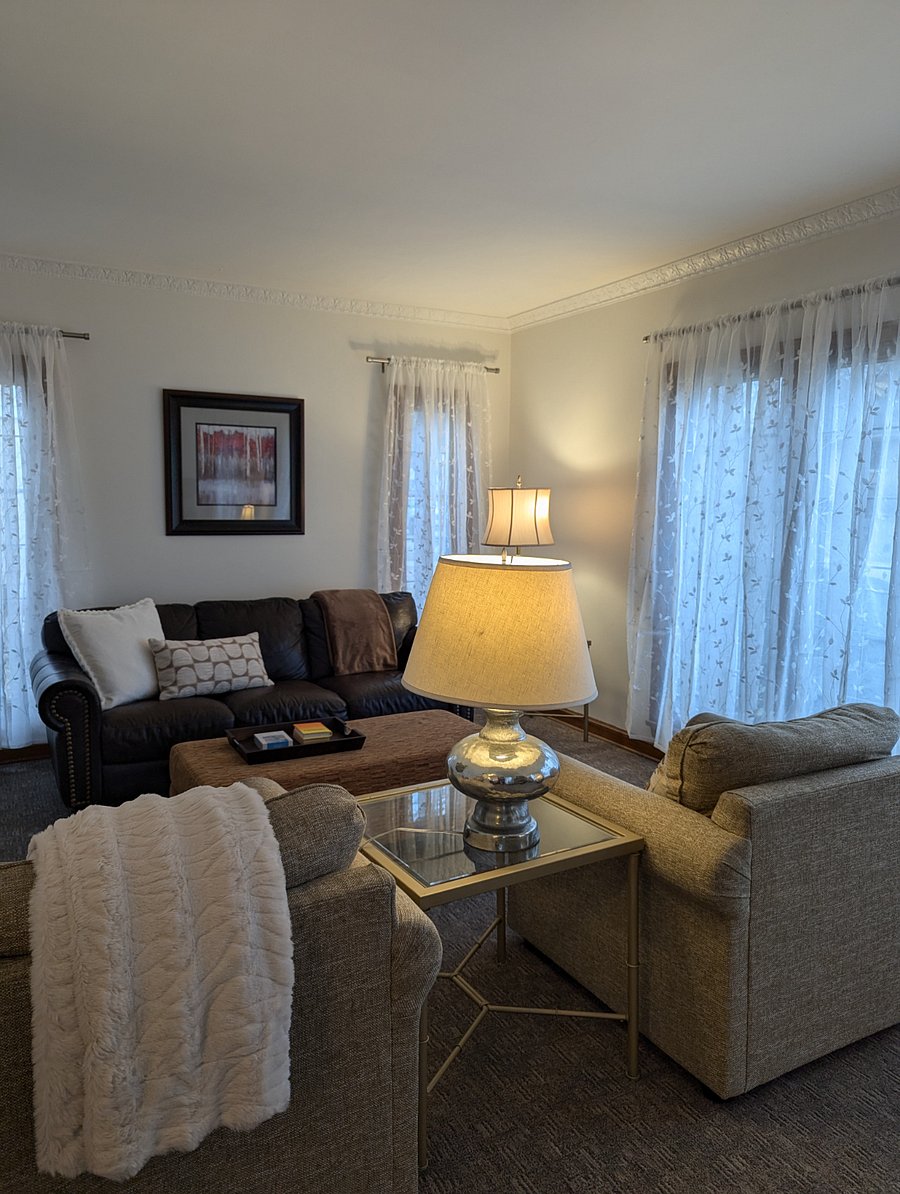 Lots of windows and original art in the comfortable living room.