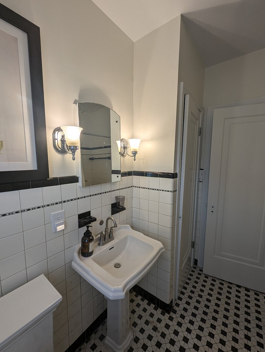 Medicine cabinet behind the mirror hides even more storage space.