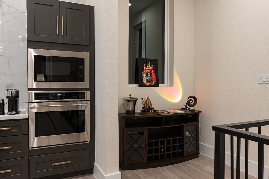 A kitchen with a built-in Monogram oven and microwave. 