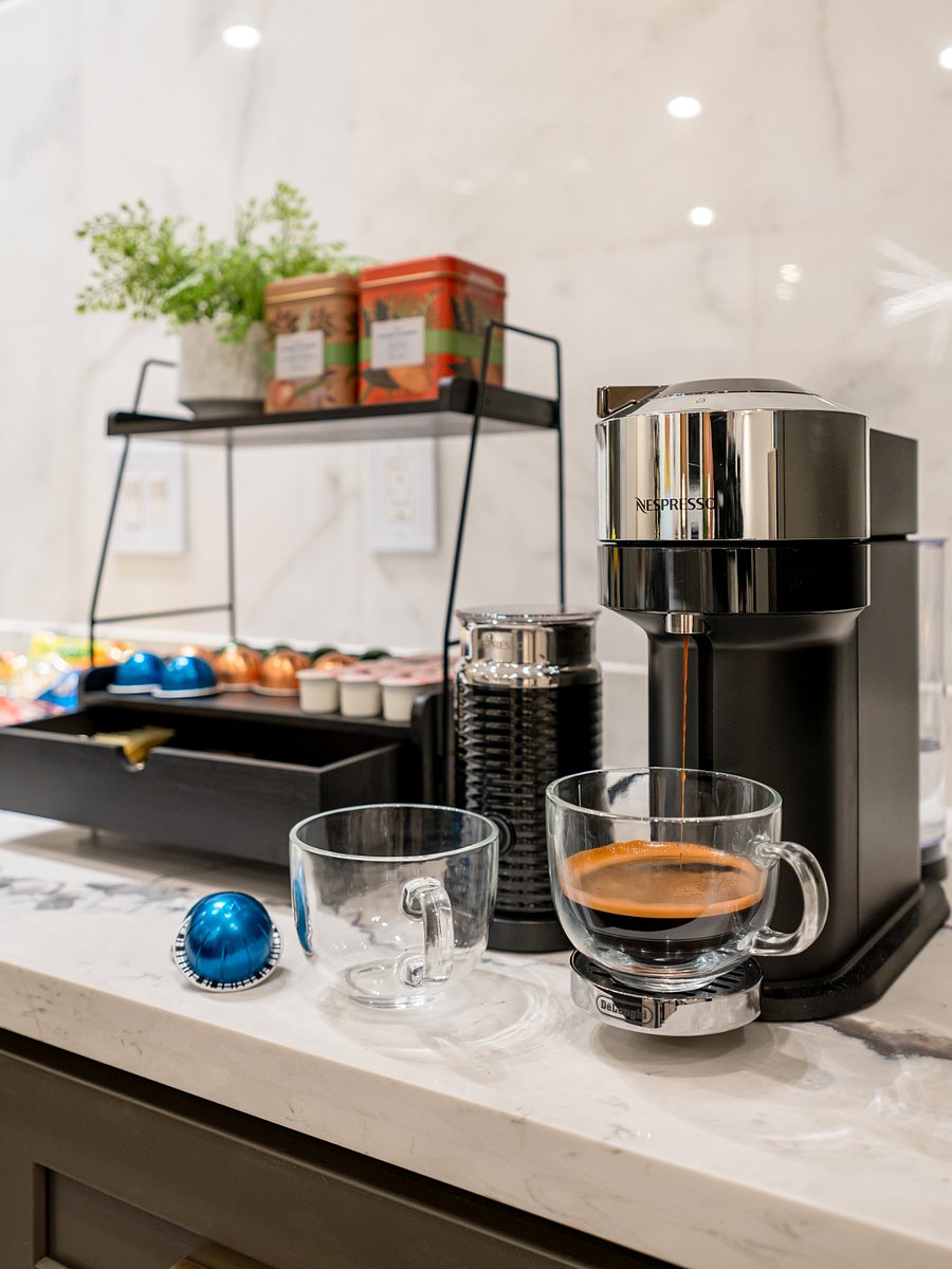 A coffee maker with a cup of coffee. 