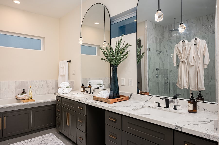 A spacious bathroom with a double vanity, a large mirror, and a shower on the third floor