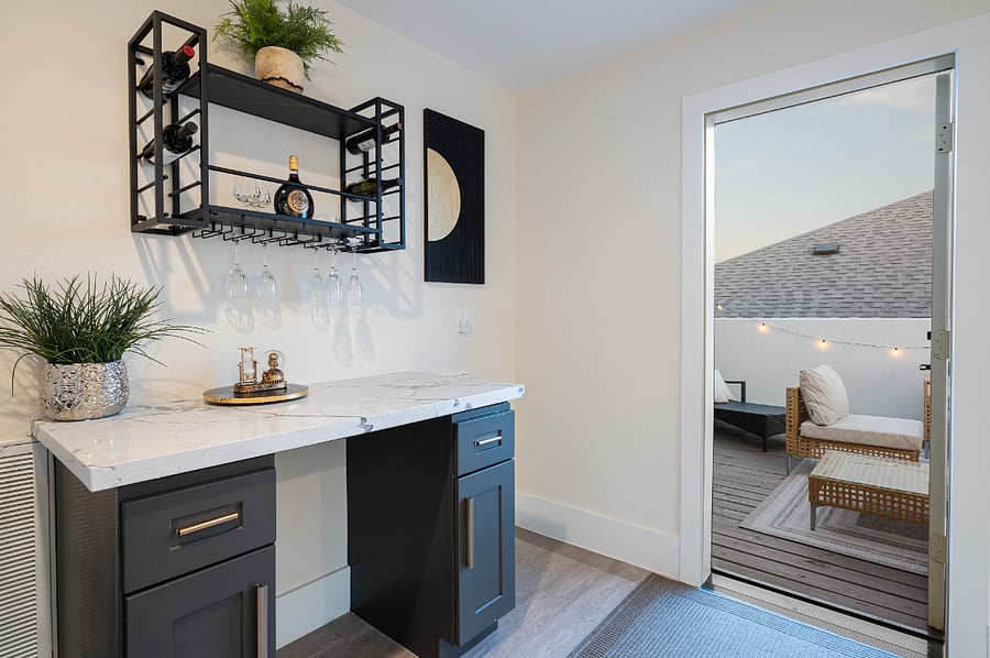 Step into luxury with this cozy and elegant bar nook, complete with a wine rack, marble countertop, and a sophisticated aesthetic for a memorable stay. 