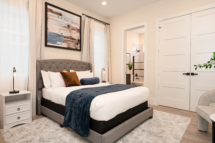 1st floor bedroom with queen bed, comfortable mattress, combination of regular and cooling pillows, soft luxury linens and chic design 