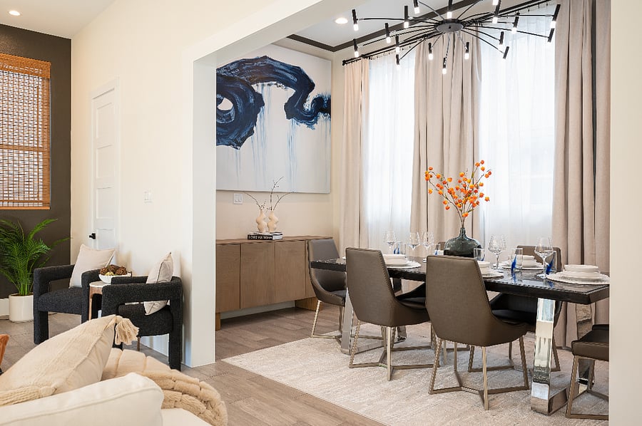Separate dining area with marble table, modern abstract art, designer lighting and luxury drapes. Perfect for a meal with friends and family 