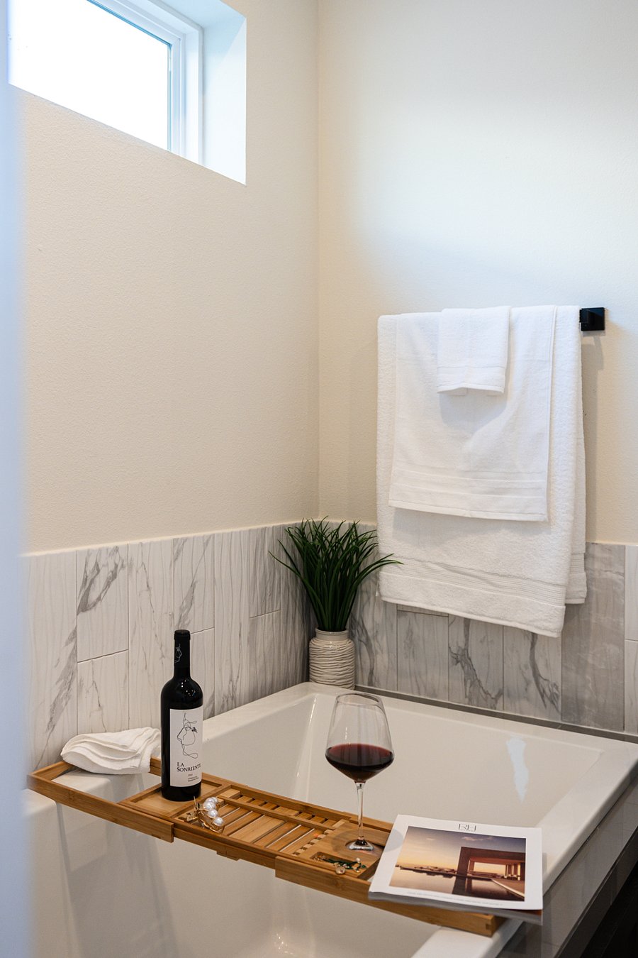 Relaxing Bathroom with Soaking Tub and Wine 