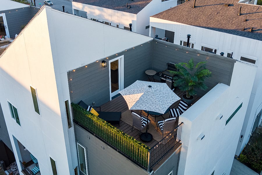 An aerial view of a house with a rooftop deck.