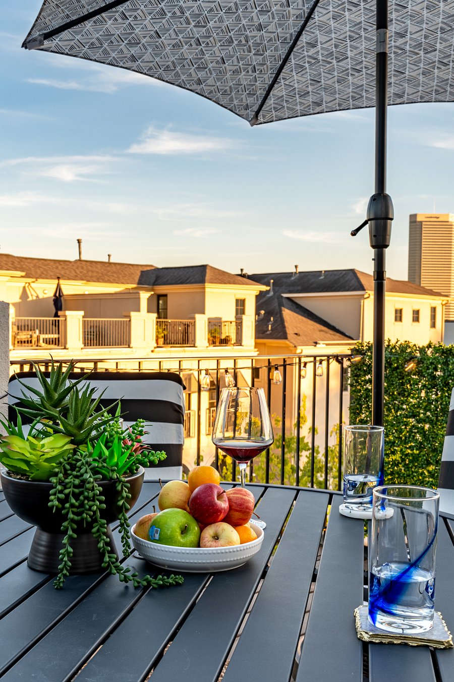Relaxing on the balcony with a glass of wine and a beautiful city view.