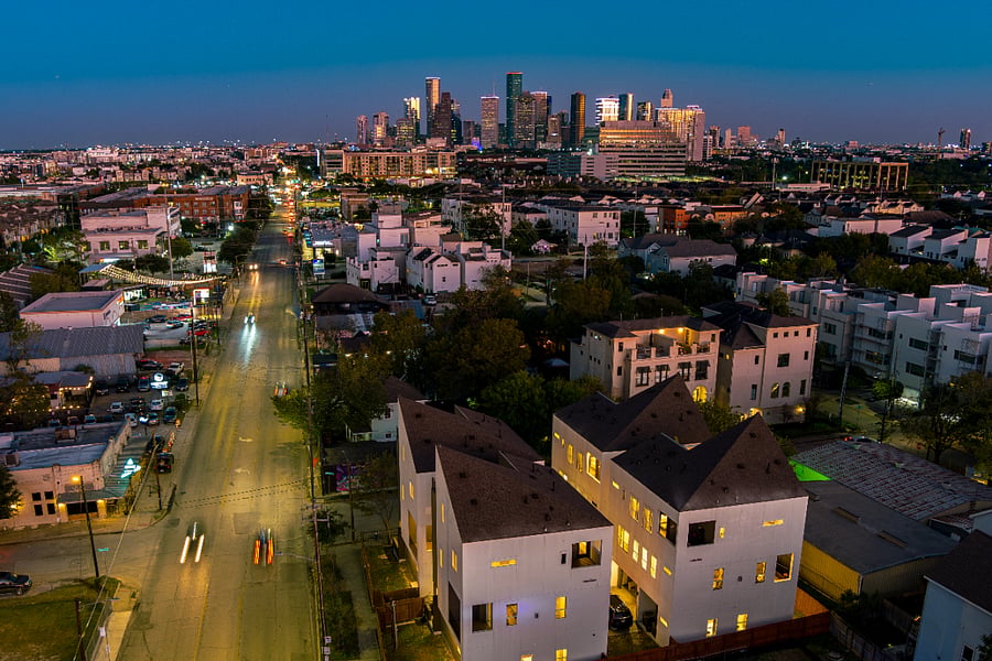 A nighttime aerial view of the house with Houston downtown view in the background.