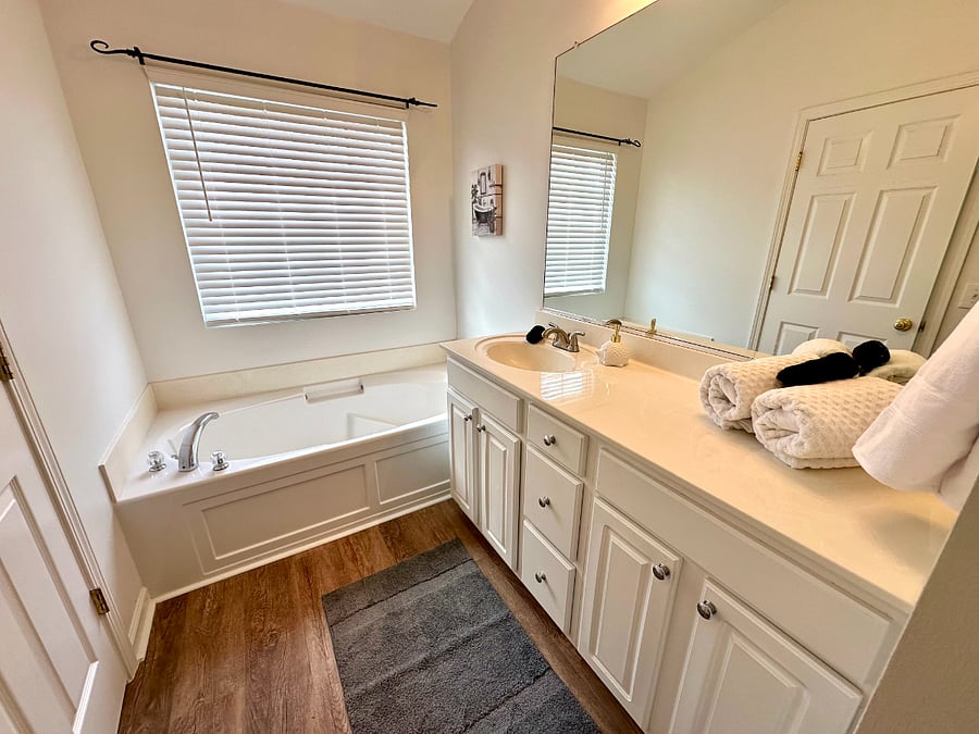 Primary bath with huge cabinet, good lighting, and vanity. 