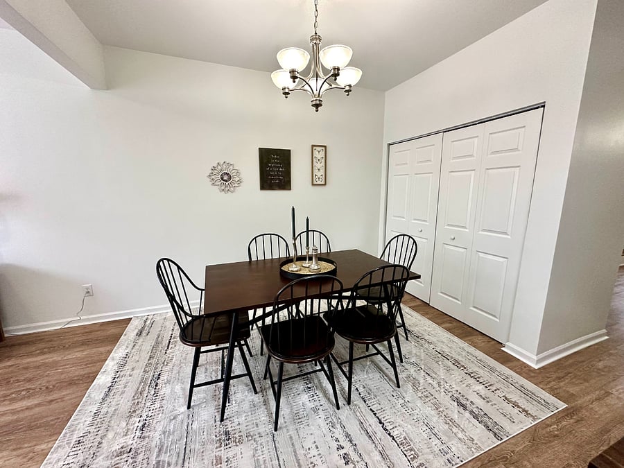 Spacious dining room seathing for four open/adjacent to the kitchen. Doors to the right are laundry with washer/dryer provided and detergent to get you started. 