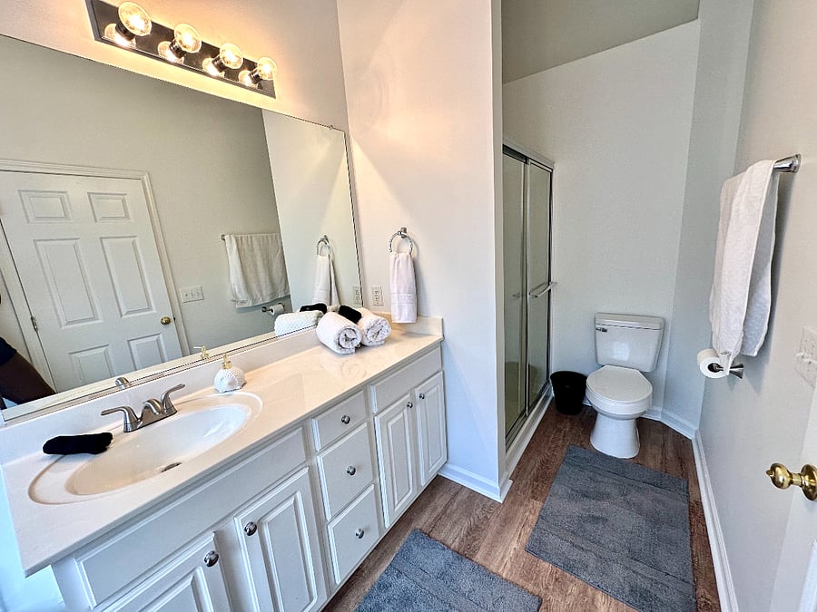 Primary bath also has a separate shower with glass doors. 