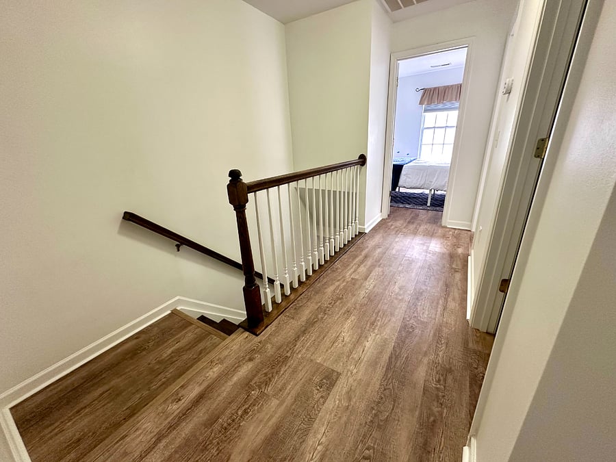 Landing area with entrances to all three bedrooms and the hall bath. 