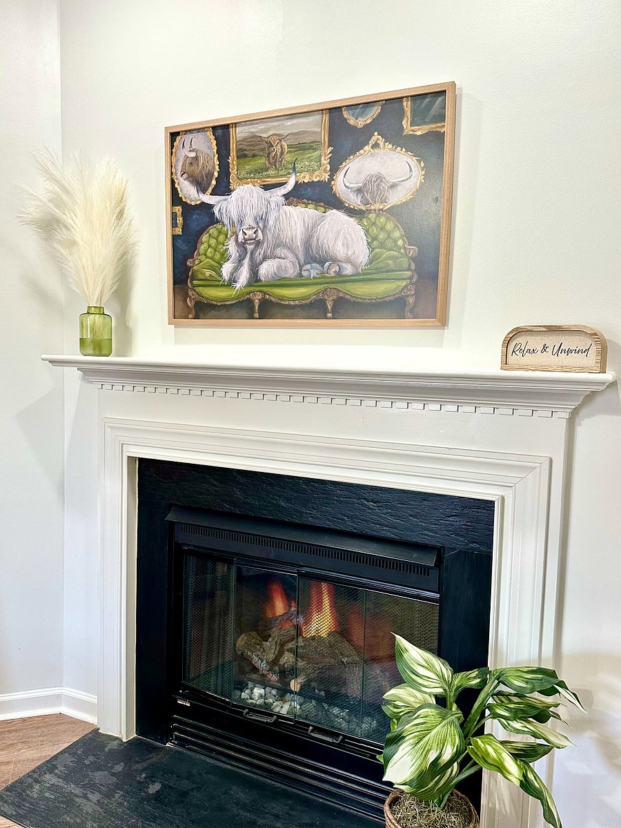 Fireplace with electric heater and mantle.
