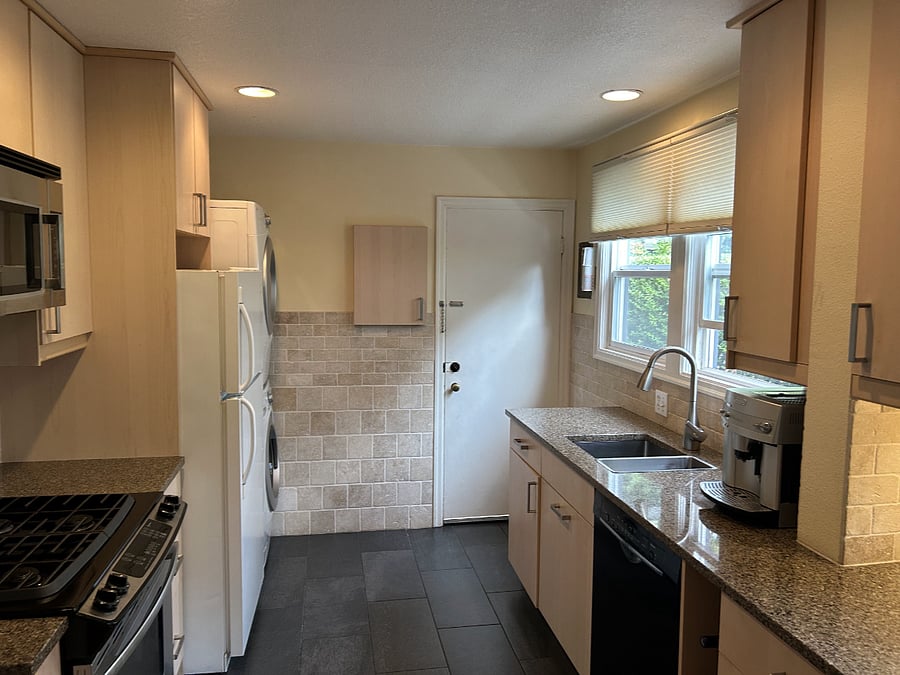 Full size range, dishwasher and fridge with quartz countertops
