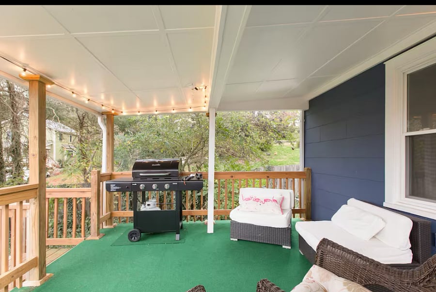 Gas grill and outdoor furniture on the covered back deck.