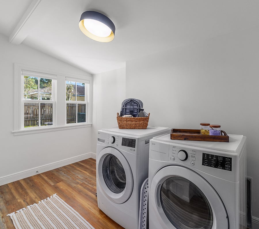 Back entrance leads into laundry room with full washer and dryer