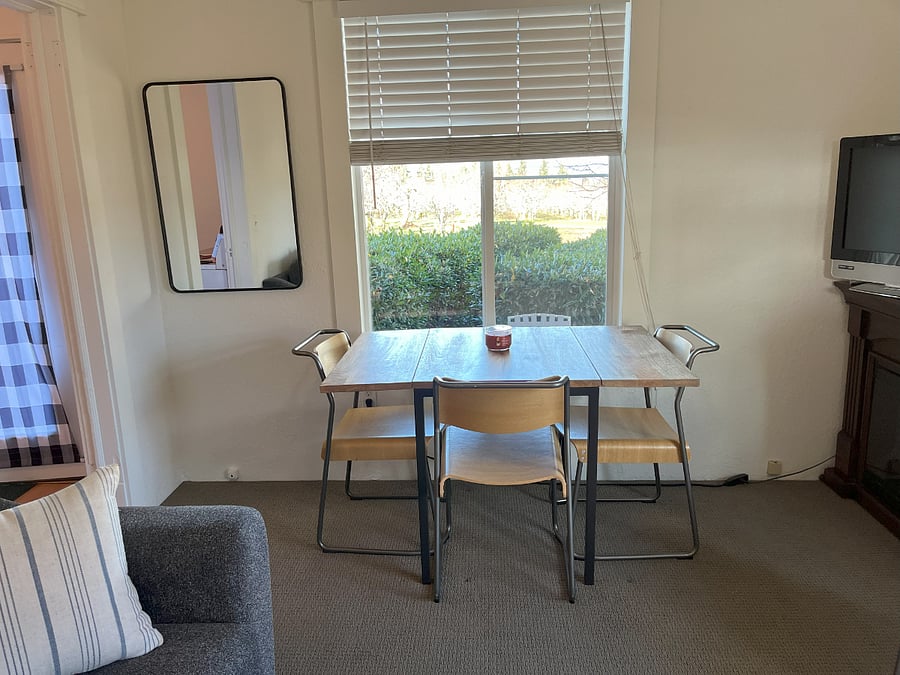 Dining table in living area, Roku TV, electric fireplace