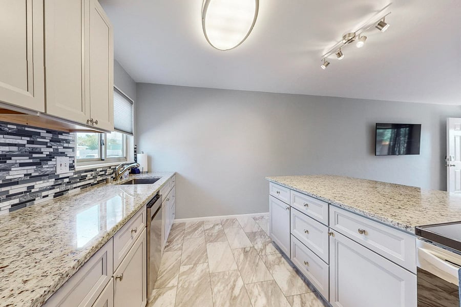 Remodeled kitchen with granite counters, tile backsplash, plenty of cabinet space, and all new appliances