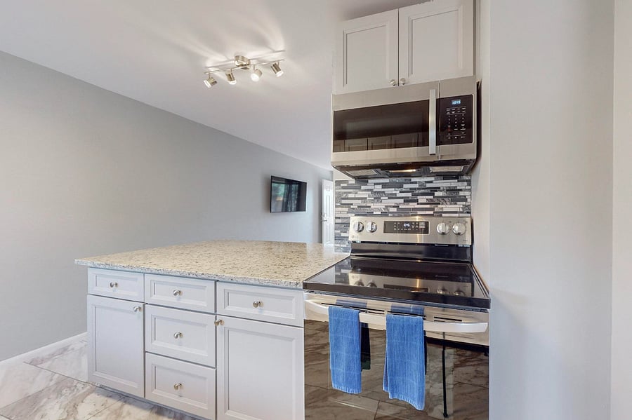 Remodeled kitchen with granite counters, tile backsplash, plenty of cabinet space, and all new appliances