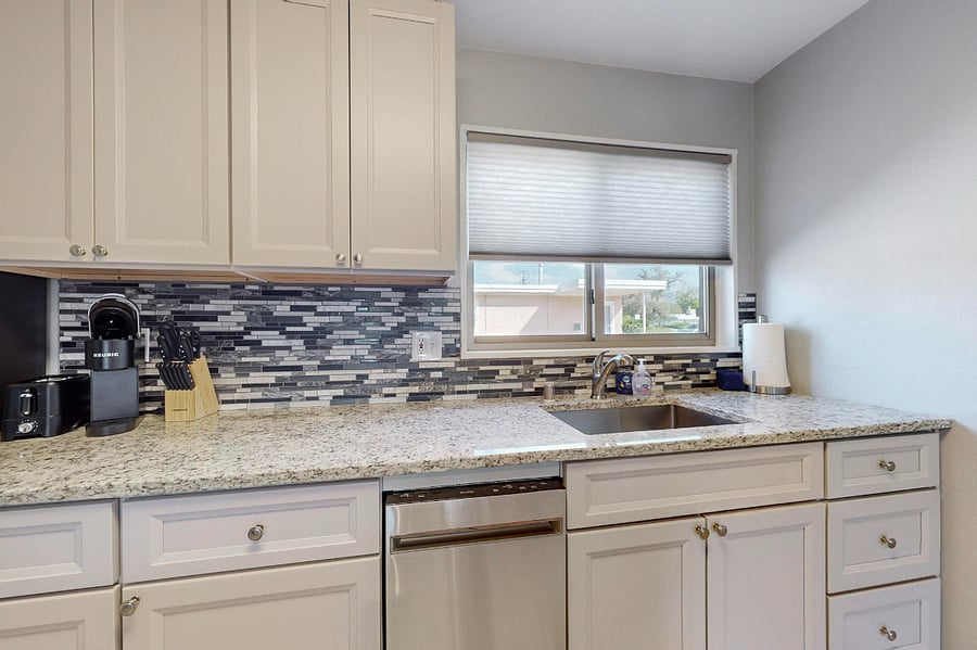 Remodeled kitchen with granite counters, tile backsplash, plenty of cabinet space, and all new appliances