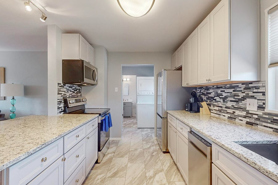 Remodeled kitchen with granite counters, tile backsplash, plenty of cabinet space, and all new appliances