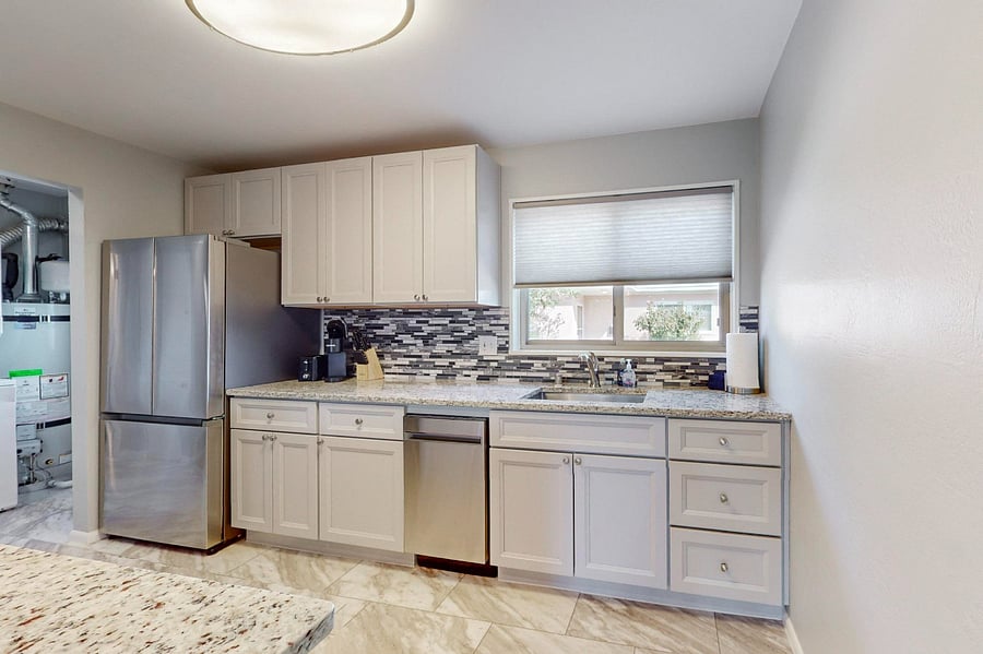 Remodeled kitchen with granite counters, tile backsplash, plenty of cabinet space, and all new appliances