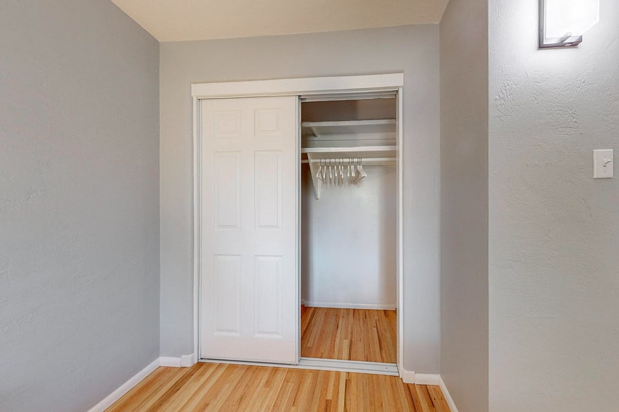 Large bedroom with king-sized bed, dresser, large closet