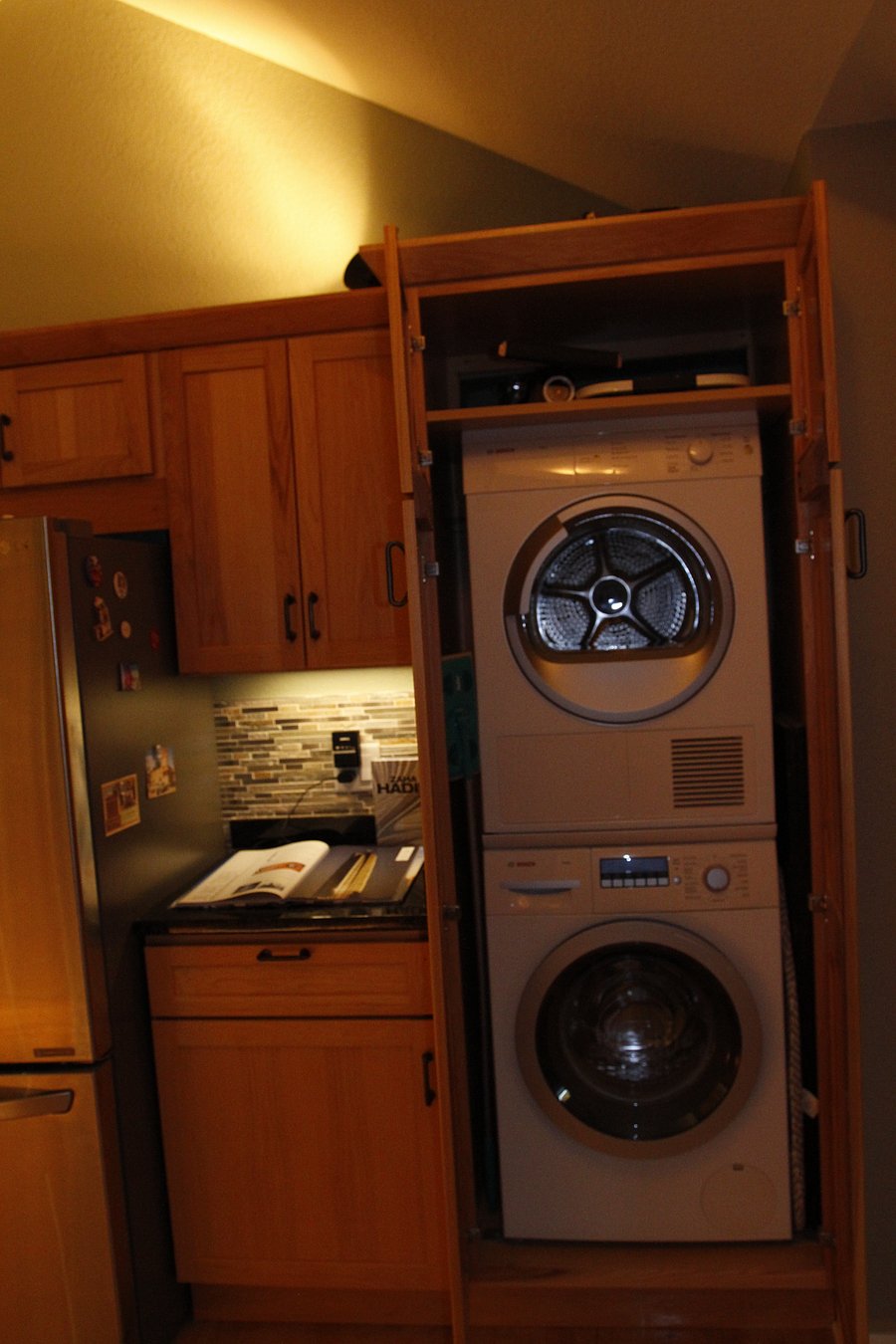Laundry concealed in kitchen cabinet