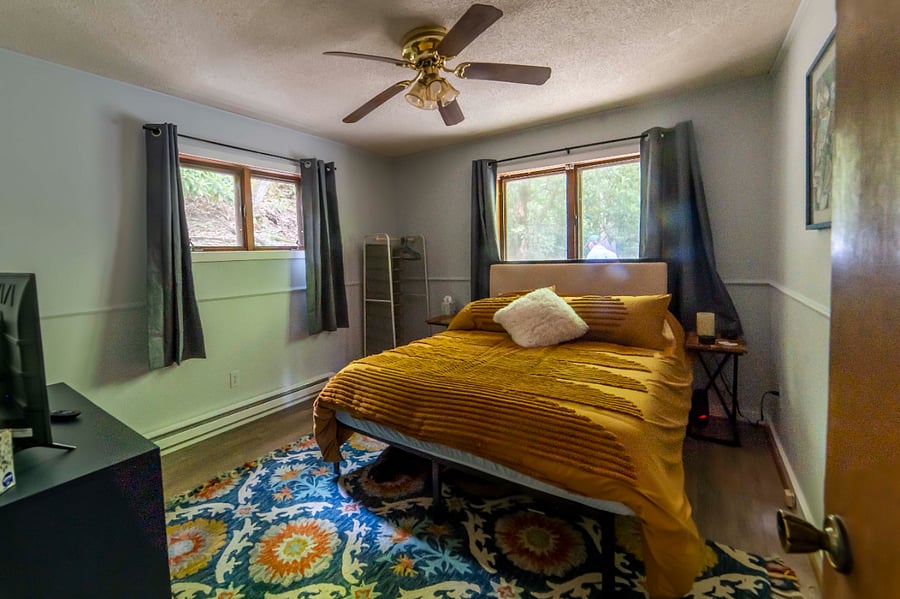 Main Floor Bedroom 1 - Queen with ceiling fan and smart TV 
