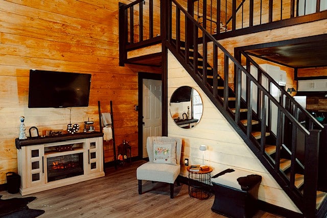 tv fireplace view of the living room, stair entrance and kitchen to the right hand side. The back door leads to the back of the cabin where the outside shower and yard are located.