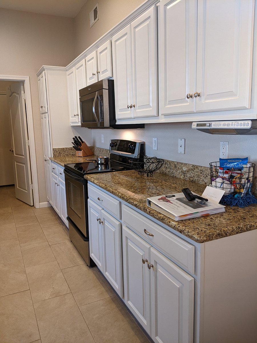 Fully Stocked galley style kitchen. Stove and microwave