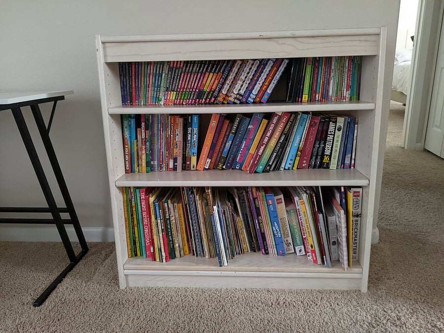 Bookshelf in the loft with many books for kids and some books for adults