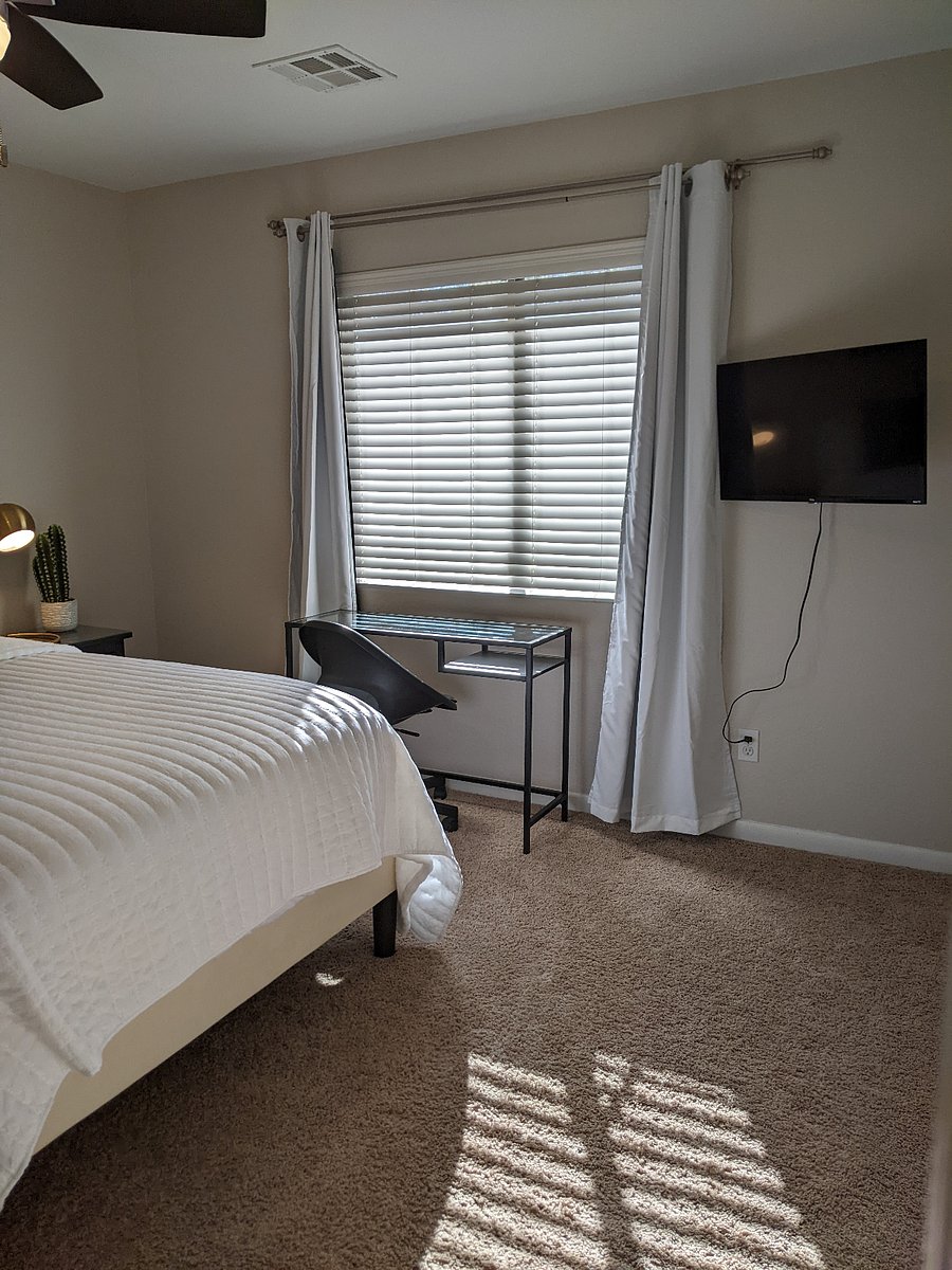 Upstairs south bedroom with comfy queen sized bed, desk and chair, and 32" Smart TV