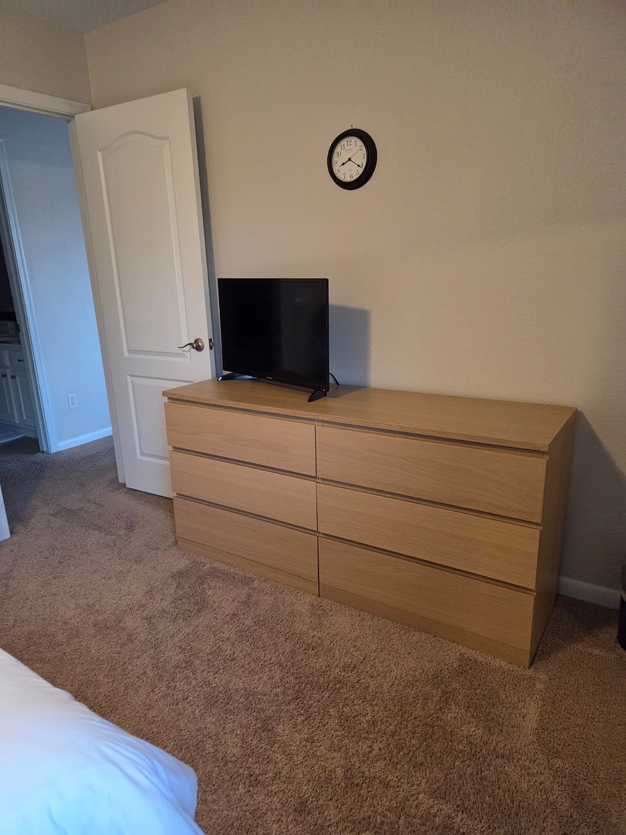 North bedroom dresser and 32" Smart TV