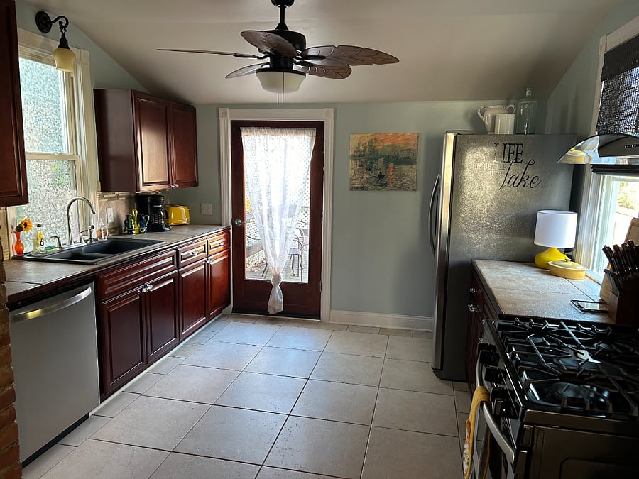 Large open kitchen with door to back deck