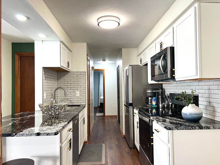 Galley style kitchen makes for the perfect work triangle, including a dishwasher to make cleaning easy.