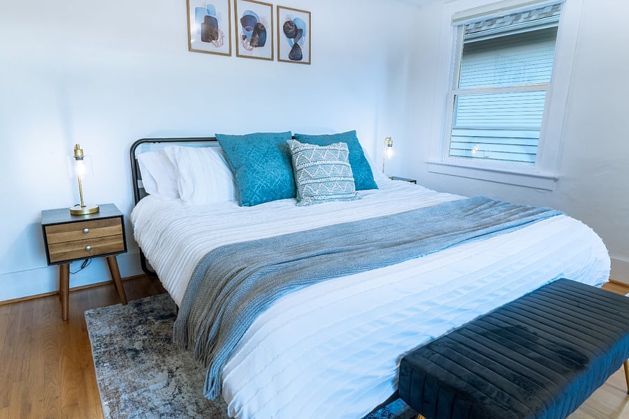 Unwind in the spacious primary bedroom featuring a comfortable king-size bed, blackout blinds and curtains for a restful nights sleep. Soft and medium firm pillows available.