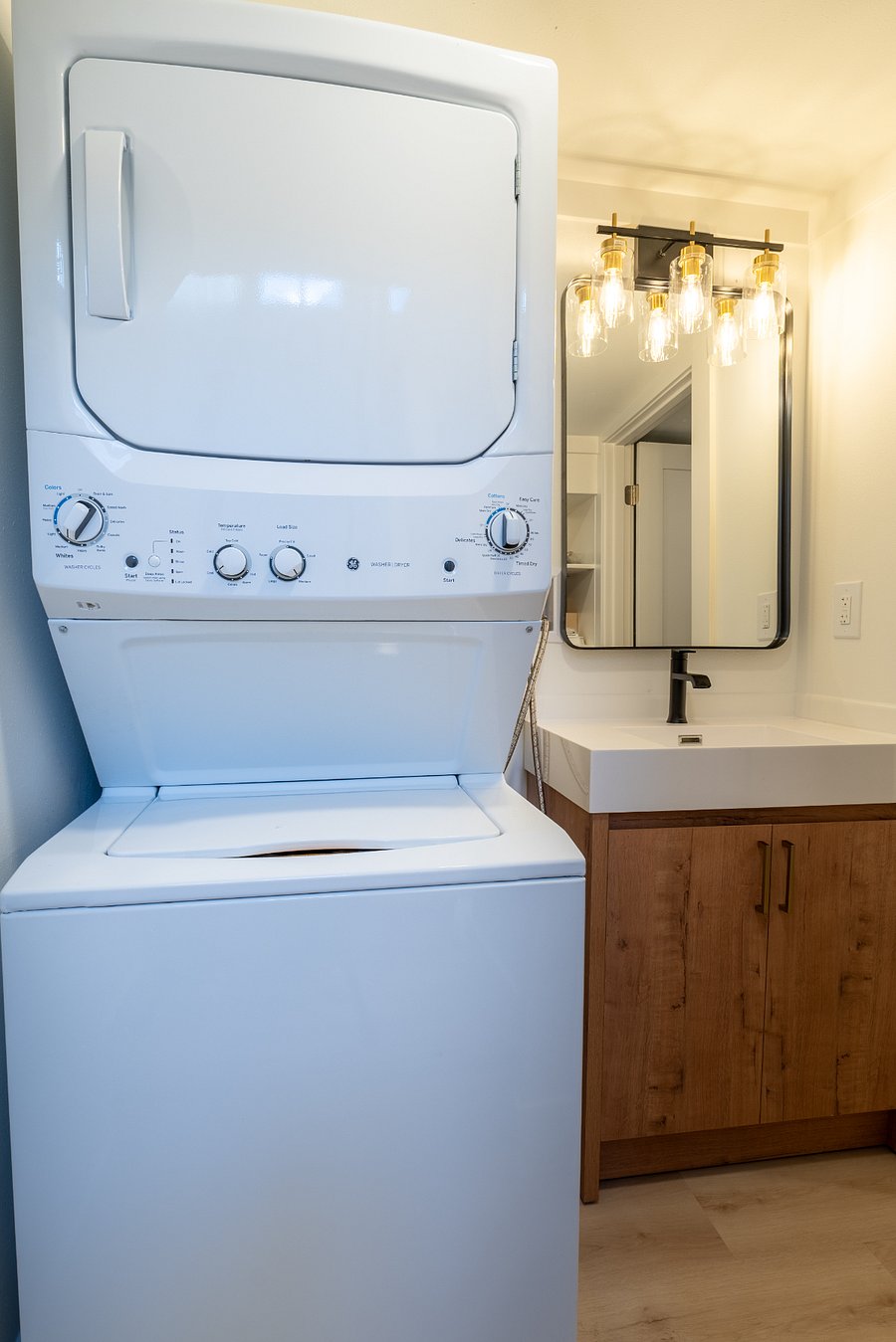 Laundry room equipped with a washer and dryer, along with starter detergent and dryer sheets. Extra bathroom vanity with sink furnished for your convenience as well.
