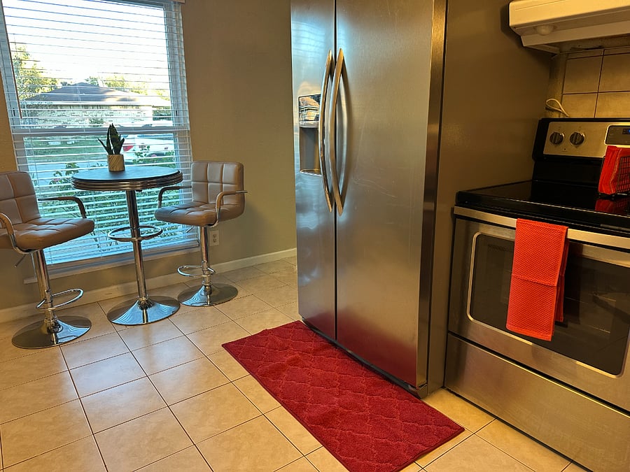 New microwave over stove and refrigerator.